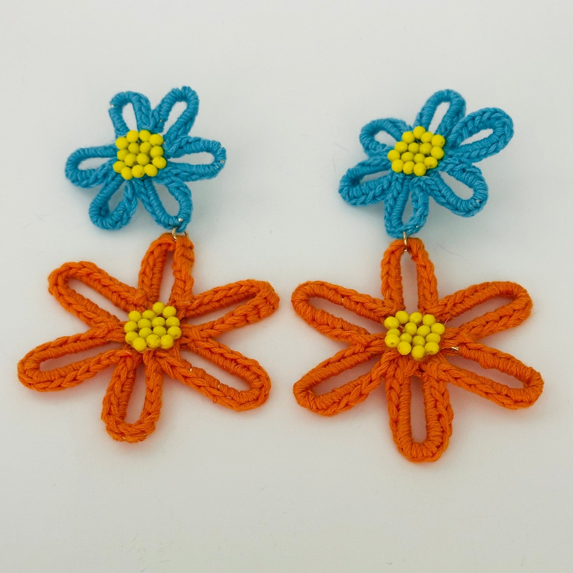 Close-up of handcrafted yarn earrings featuring vibrant, eco-friendly designs for sustainable fashion.