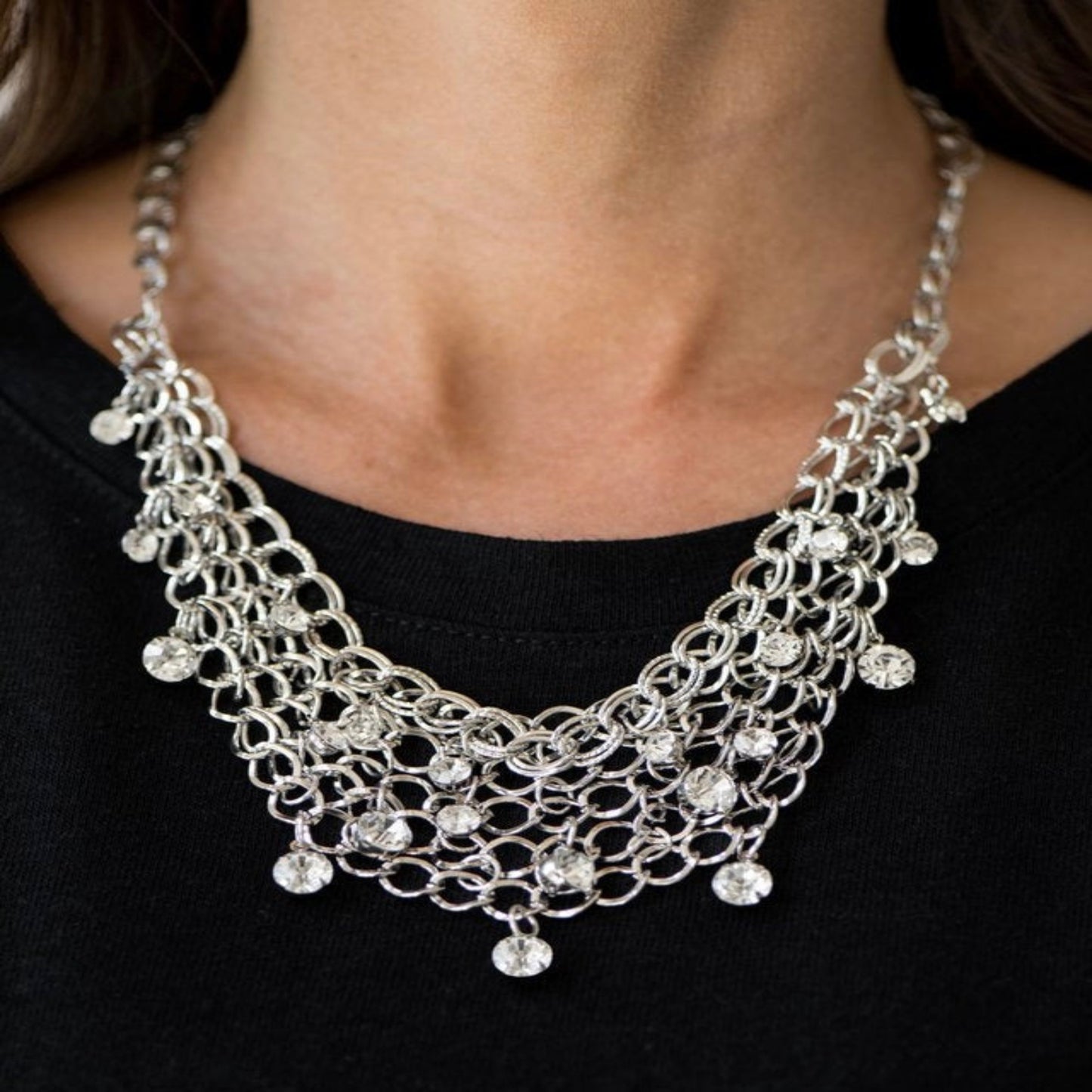 Close-up image of a delicate silver necklace with a minimalist ideal
for adding elegance to any outfit.
