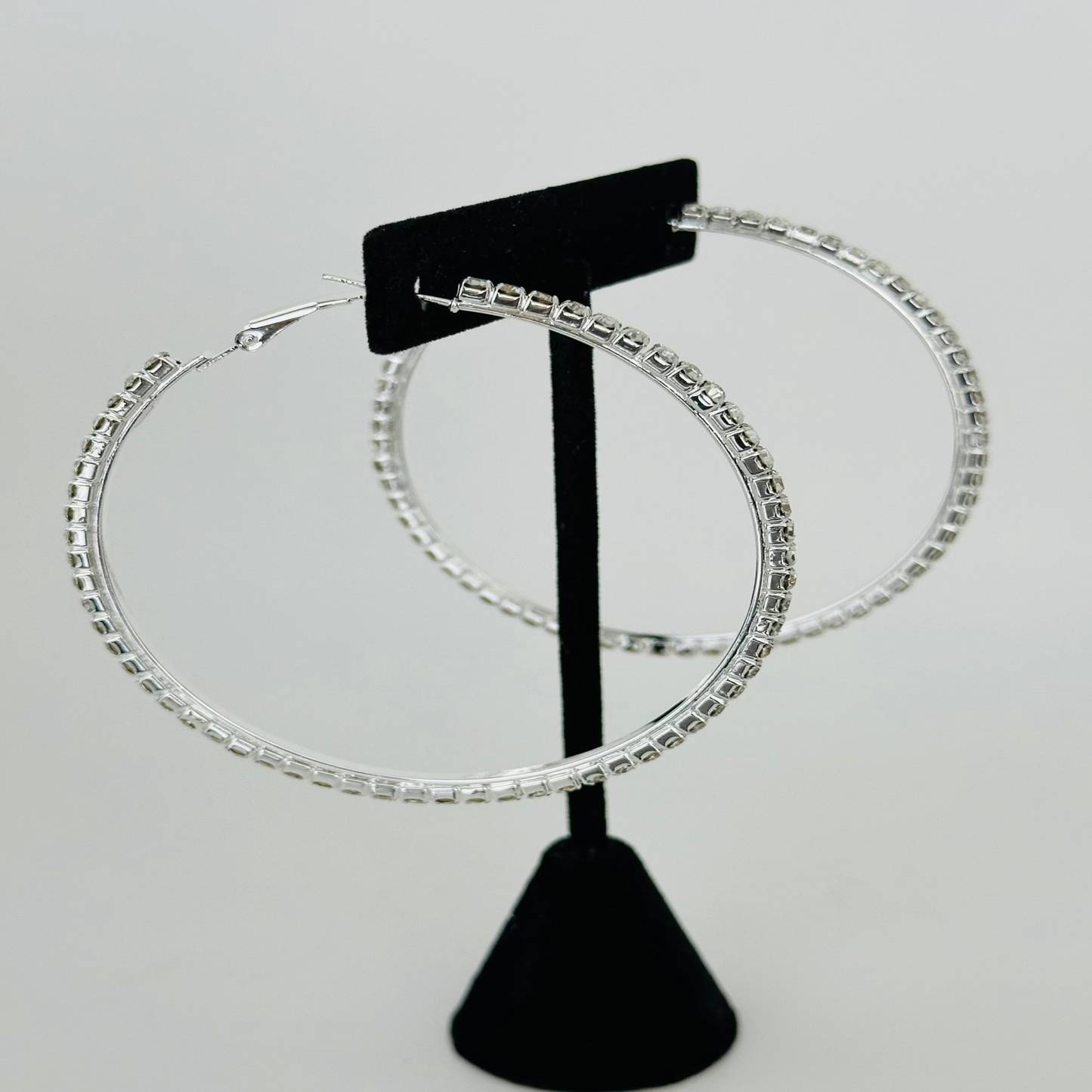 Close-up image of sparkling rhinestone hoop earrings with a sleek and elegant design.