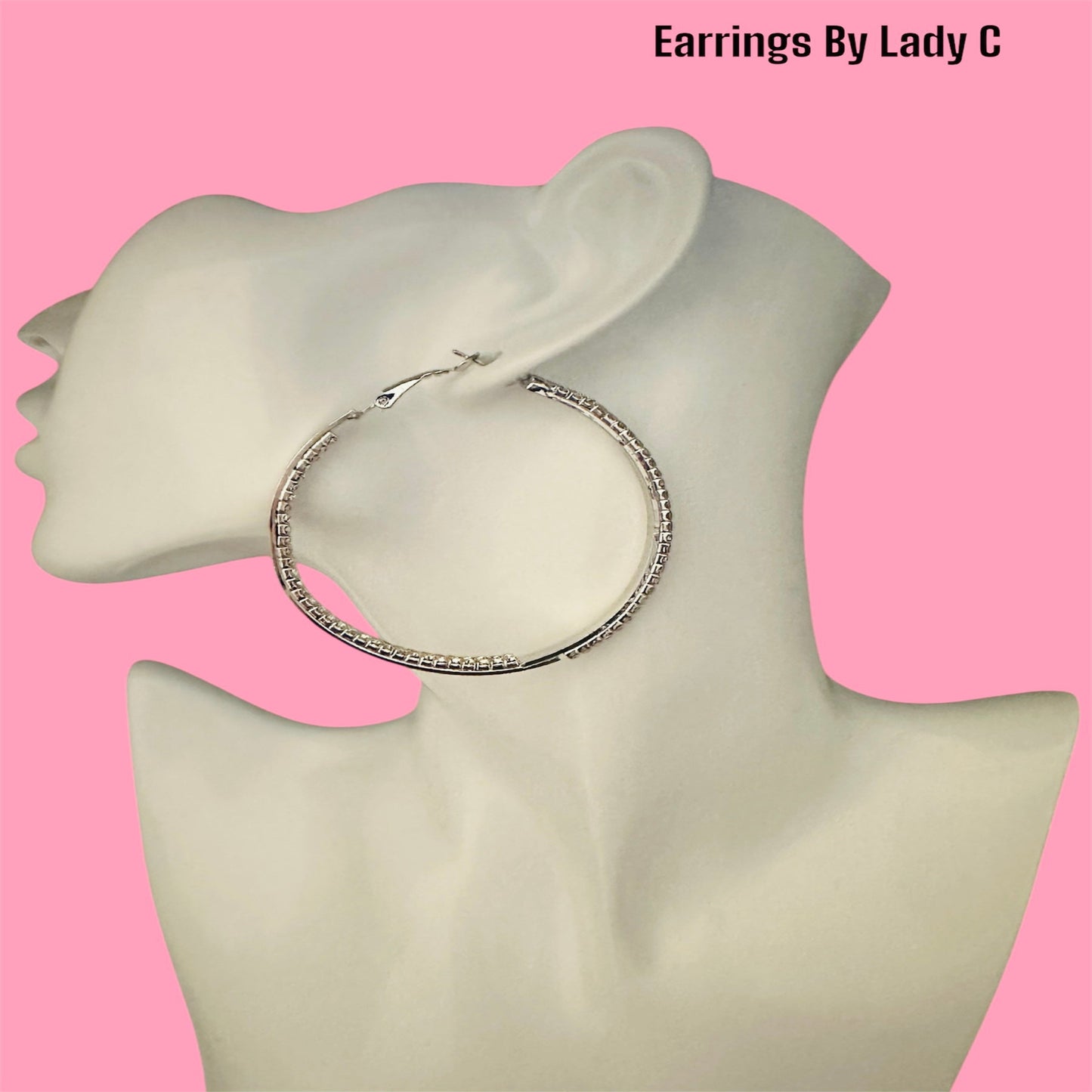  Elegant silver hoop earrings adorned with sparkling rhinestones – perfect for a chic and stylish look.