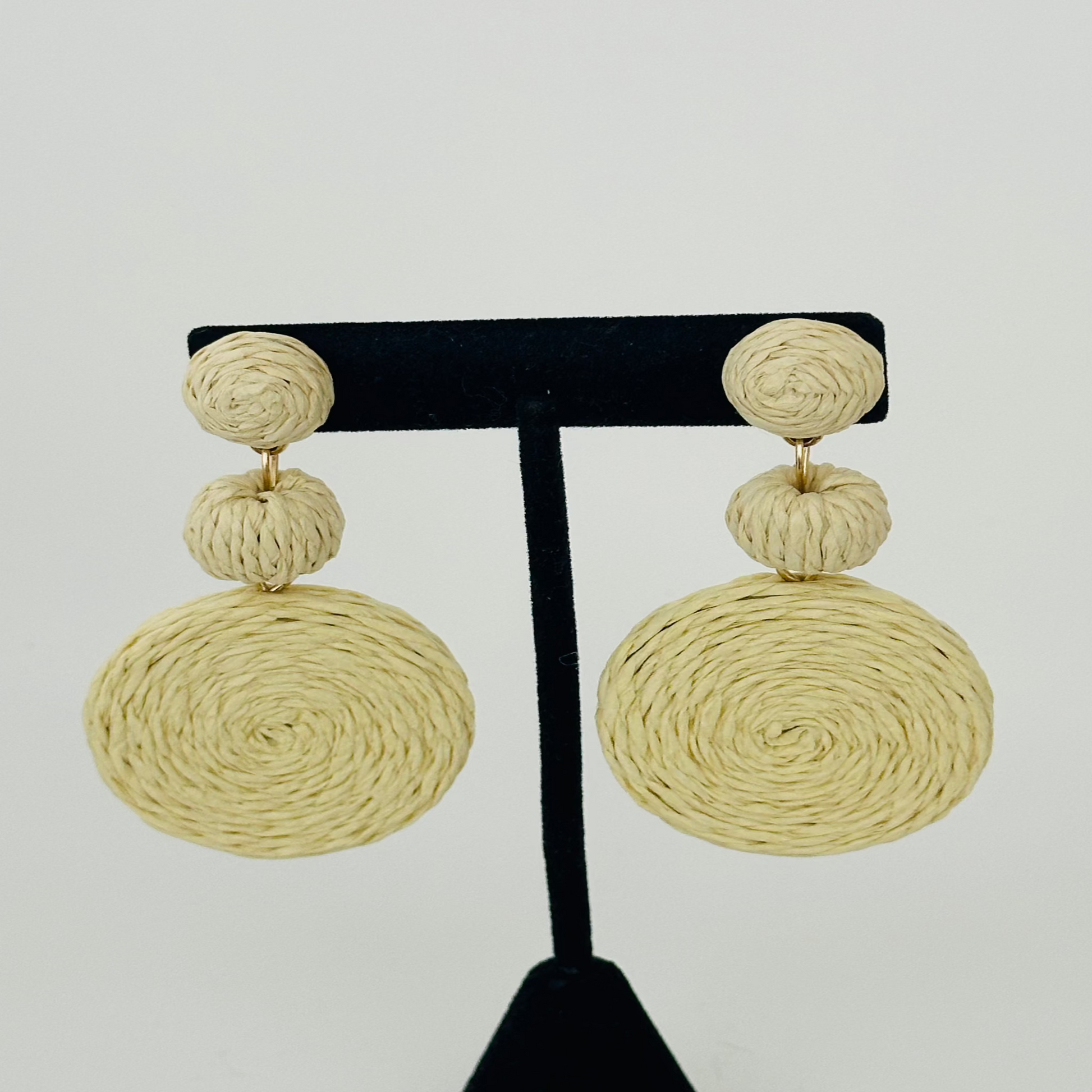 Close-up image of braid earrings with intricately woven textures, designed for a chic and contemporary look.

