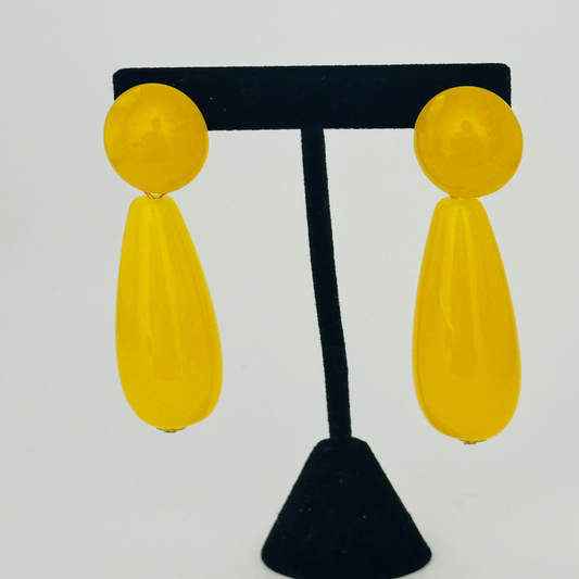 Close-up image of elegant yellow earrings with a sleek gold finish, perfect for adding a pop of color to any outfit.

