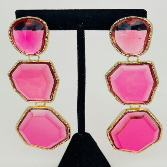 A pair of elegant dangle earrings with intricate detailing, perfect for adding a stylish touch to any outfit.

